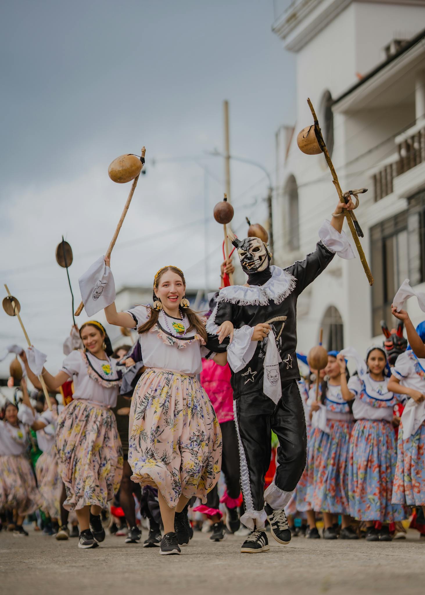 Energetic street parade showcasing traditional costumes and dances, featuring vibrant colors and cultural masks.